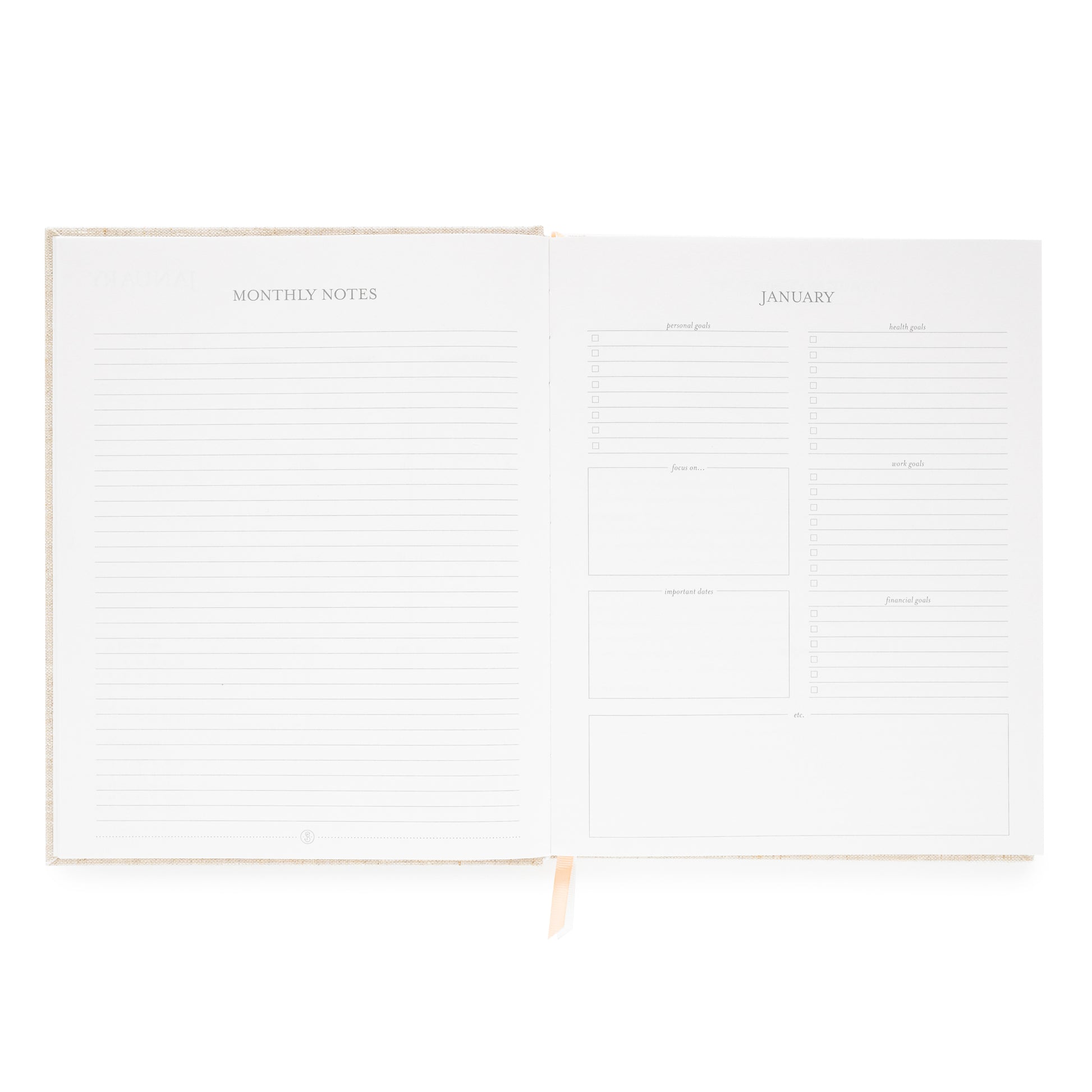 Interior of desk agenda with monthly notes and lined page and goals and prompts including personal, health, focus work, and financial goals and space for important dates and focus on