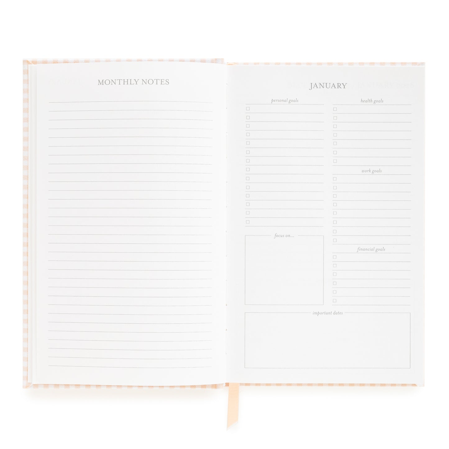 Open small bound agenda with monthly notes section and goal prompts for January