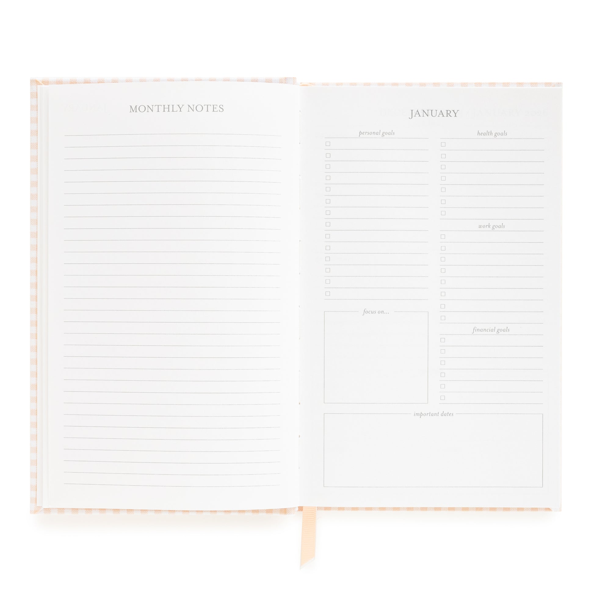 Open small bound agenda with monthly notes section and goal prompts for January