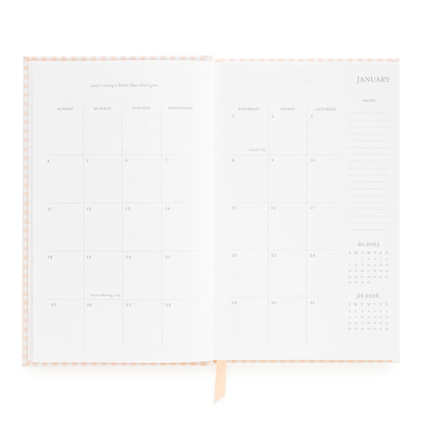 Open small bound agenda with january monthly grid with inspirational quote and space for notes on the side