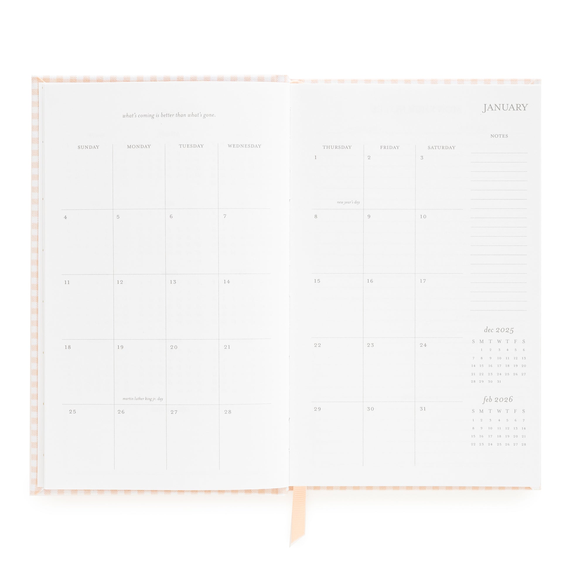 Open small bound agenda with january monthly grid with inspirational quote and space for notes on the side