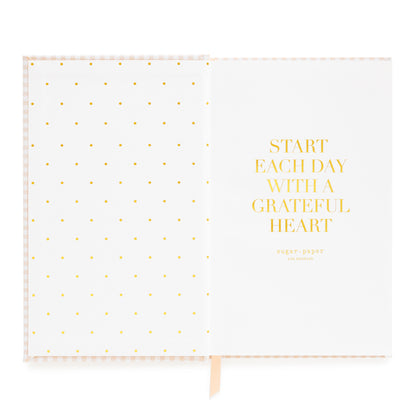 Interior of small bound agenda with 'Start each day with a grateful heart' in gold foil and pink and white ribbon markers