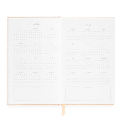 Open small bound agenda with 2026 + 2027 months of the year
