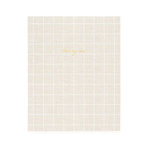 Flax and white check planner with twenty-six in gold foil on the cover