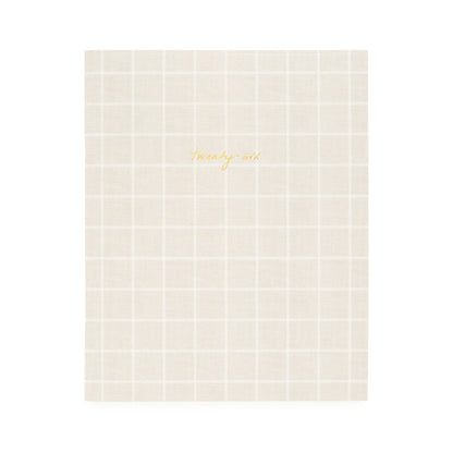 Flax and white check planner with twenty-six in gold foil on the cover