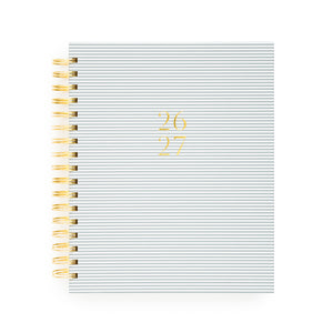 Blue stripe spiral planner with 26 27 in gold foil on the cover and a gold spiral binding