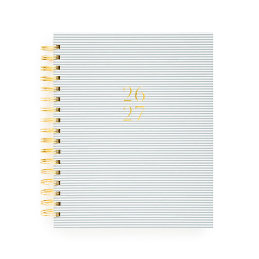 Blue stripe spiral planner with 26 27 in gold foil on the cover and a gold spiral binding