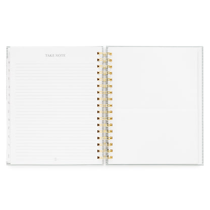 Open spiral planner with take note section with ruled lines on the left and a pocket on the right