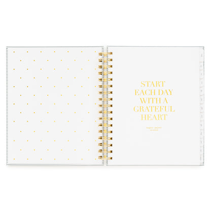 Open front cover page of the academic planner 'start each day with a grateful heart' quote in gold foil