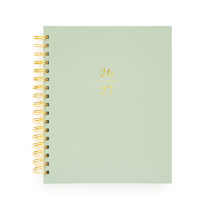 Light green planner with gold spiral binding and '26-27' in gold foil