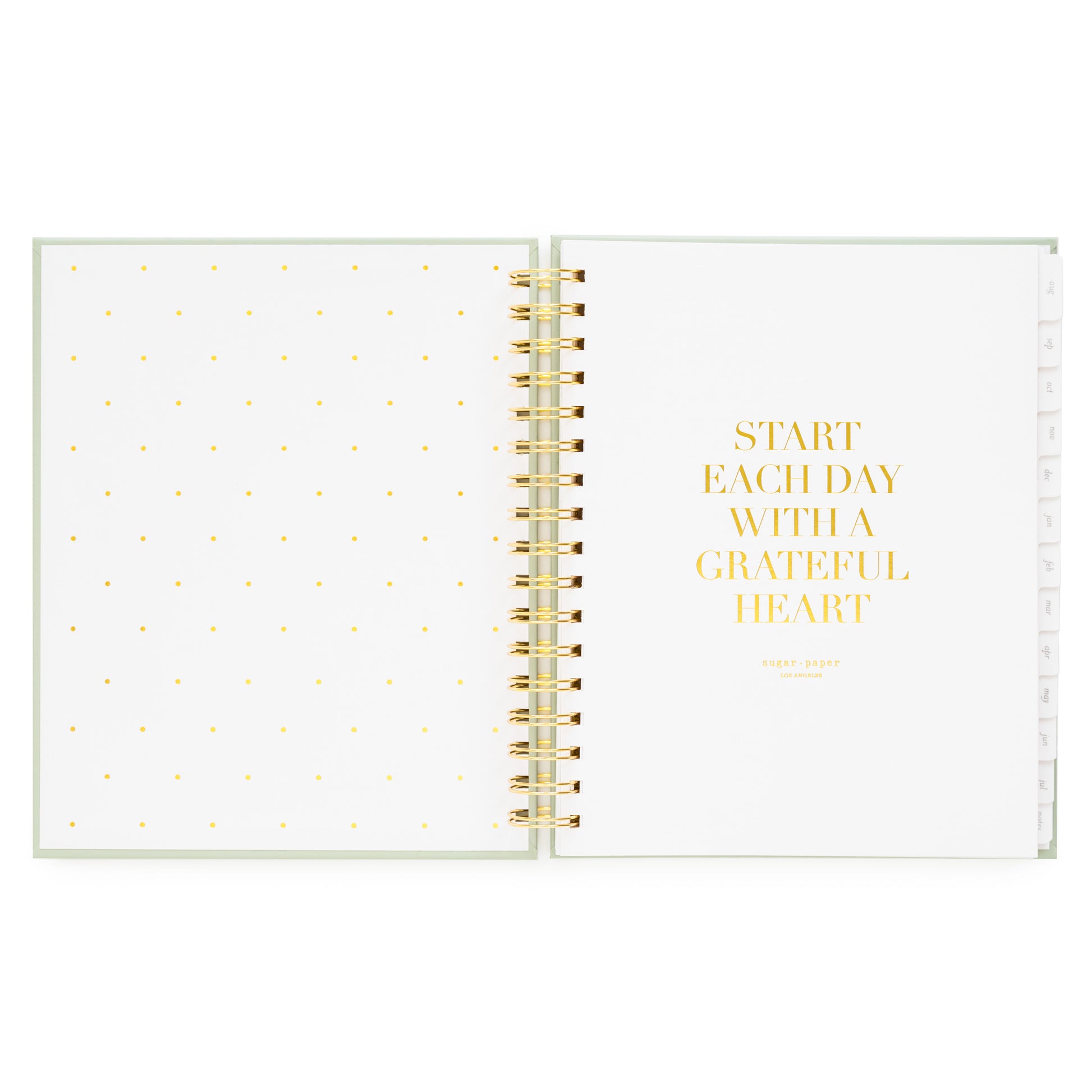 Open planner with polka dot page and 'start each day with a grateful heart' in gold foil on white background