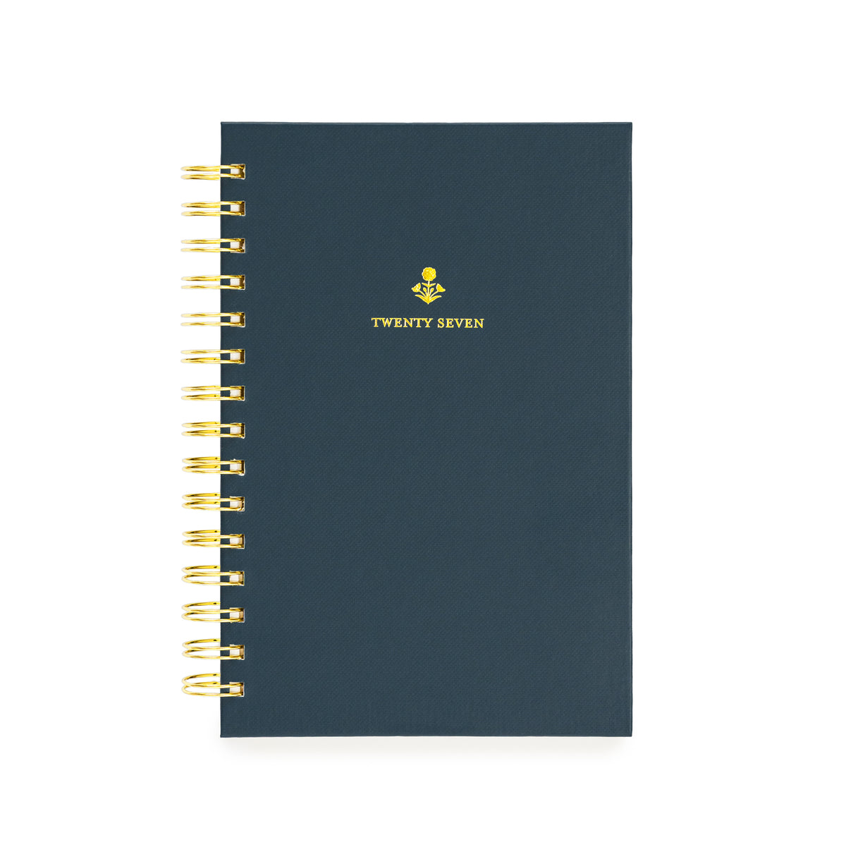 A navy spiral-bound planner with gold wire binding and a small gold floral design with 'TWENTY SEVEN' on the cover