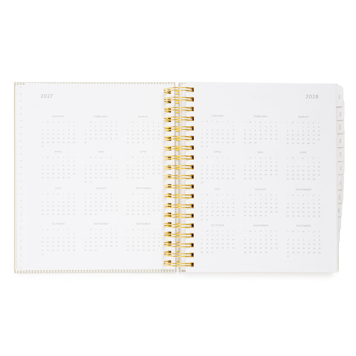 An open spiral-bound planner showing the 2027 and 2028 monthly calendar spreads on white pages, with a gold wire binding and tabs on the right showing all the calendar months
