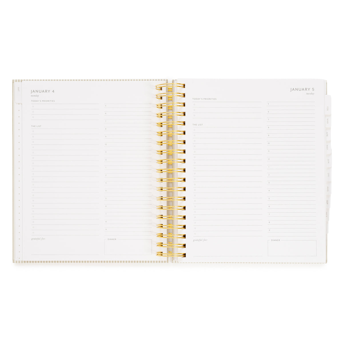An open spiral-bound planner with gold wire binding to weekly and daily layouts of january days