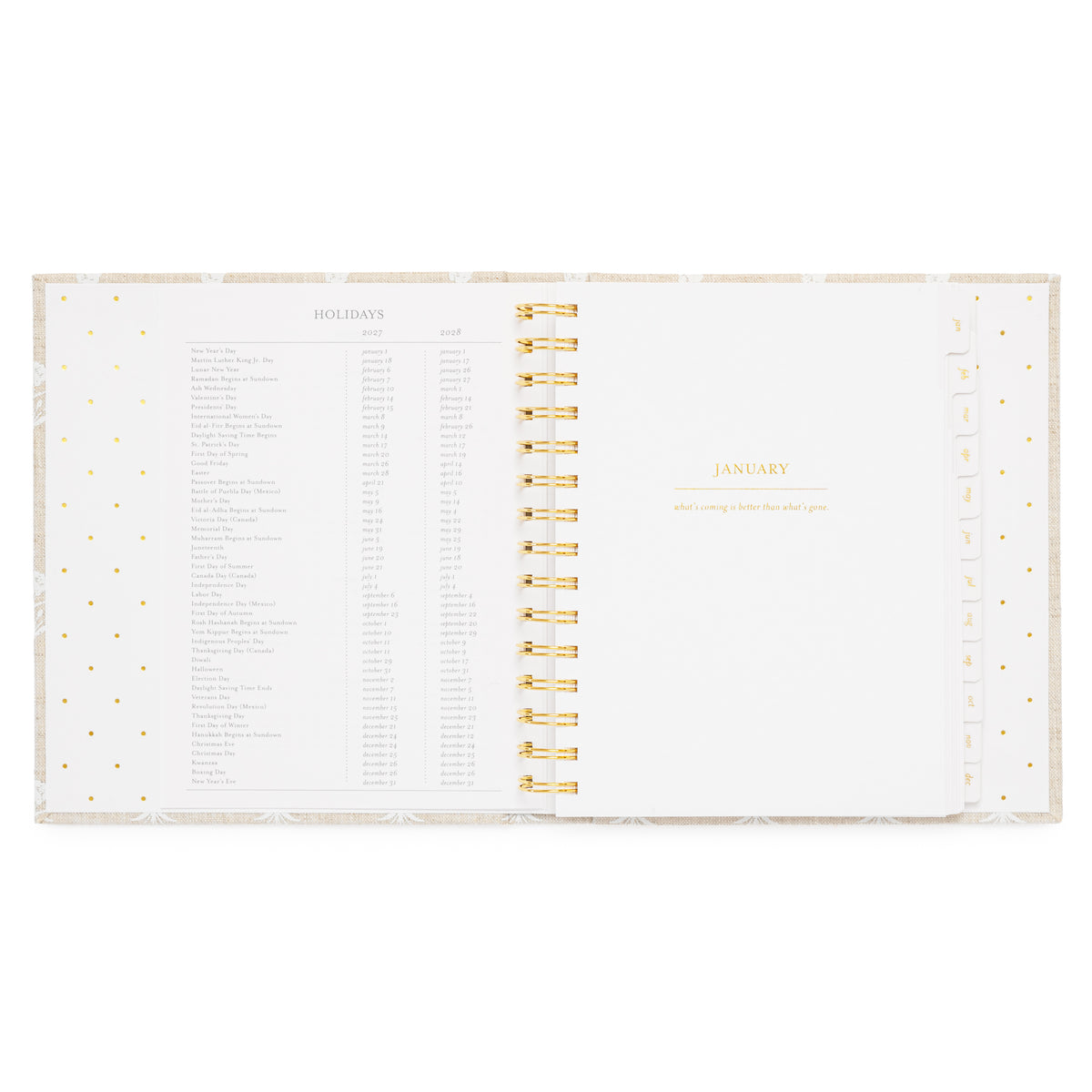 An open spiral-bound planner showing the January title page with a holiday list for 2027 + 2028 holidays on the left and gold spiral in the middle