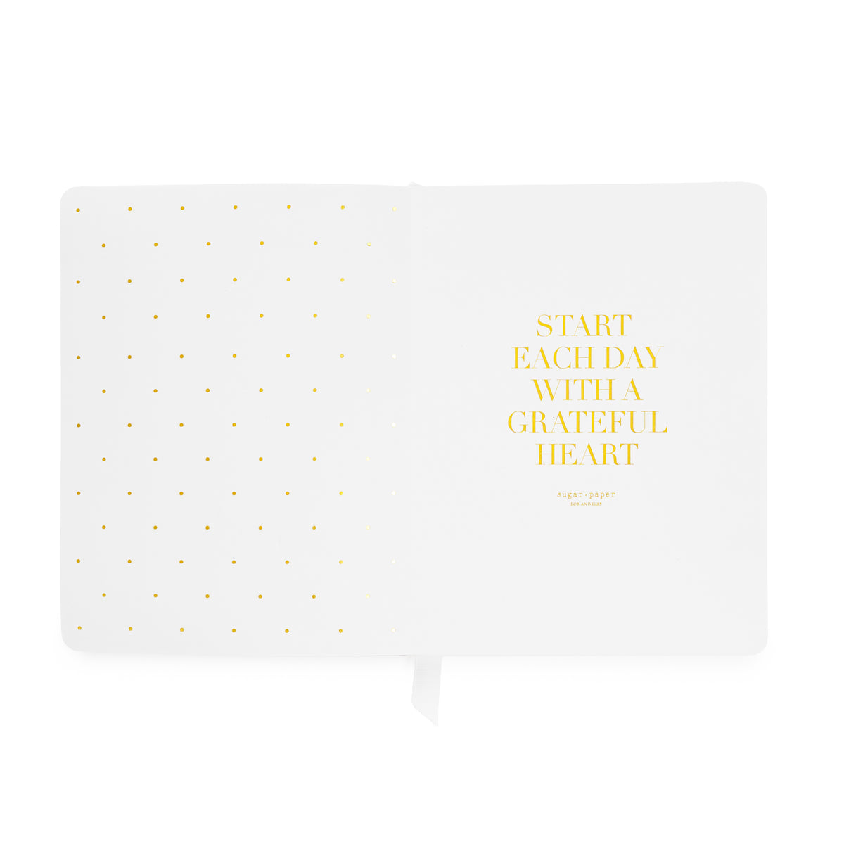 An open planner with 'start each day with a grateful heart' in gold foil with gold foil dot pattern on the left side