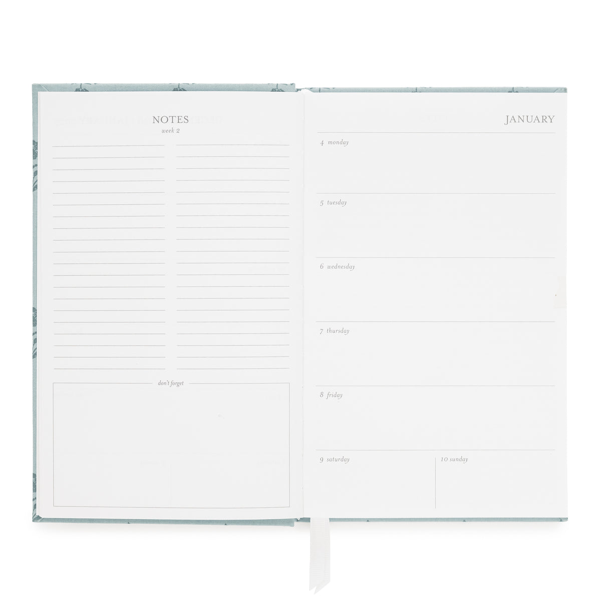 An open planner with a white interior showing lined note pages on the left and a January weekly layout on the right