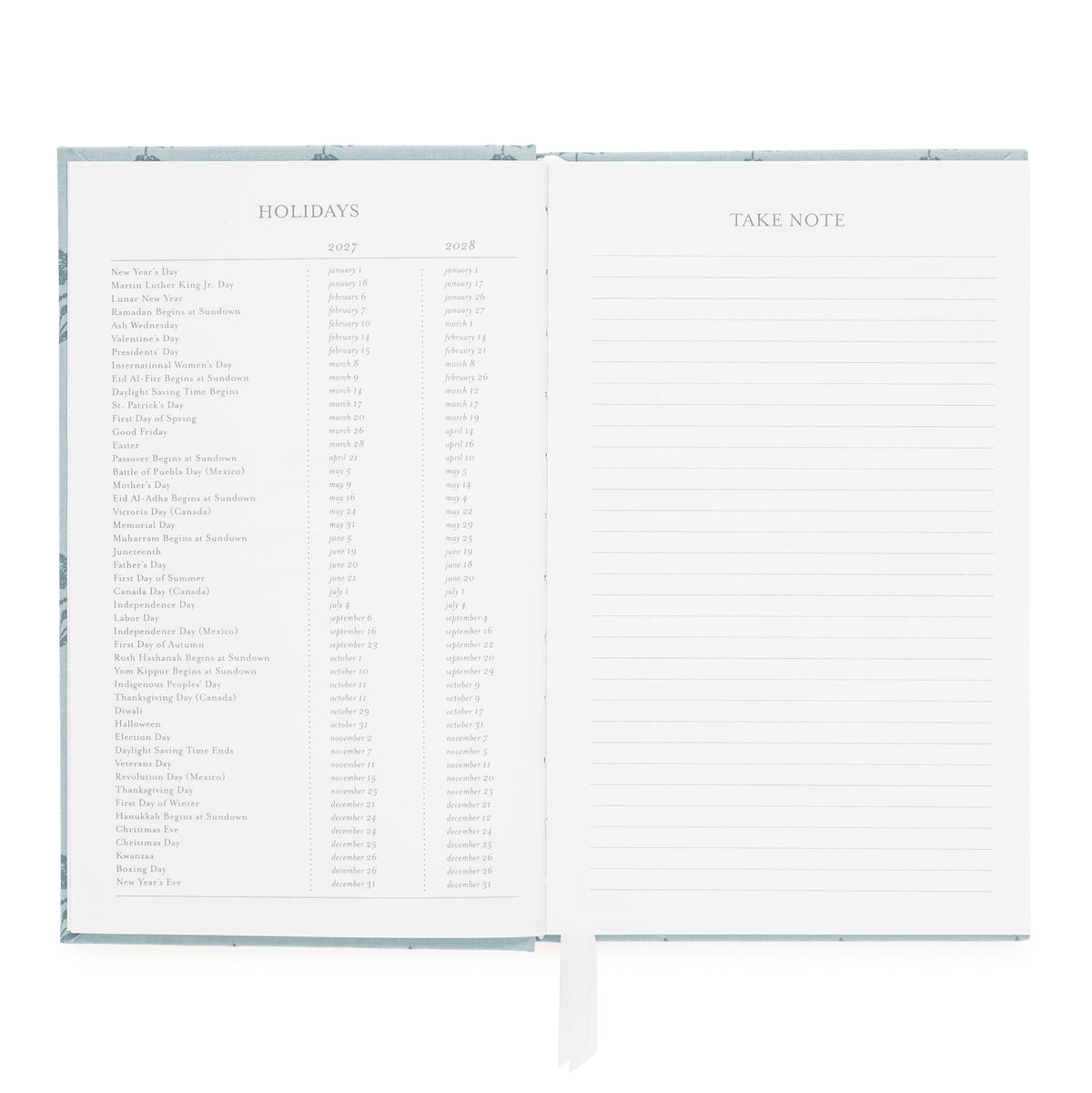 An open hardcover journal or planner showing two interior pages: a left page with a holiday list spanning 2027 and 2028, and a right page with lined space labeled TAKE NOTE with ruled lines