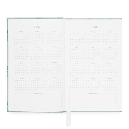 An open 2027 to 2028 calendar spread with minimalist monthly grids and blank note sections at the bottom of each page