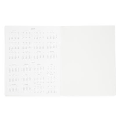 An open white planner showing a left page with printed calendar grids for 2027 and 2028, and a blank right page