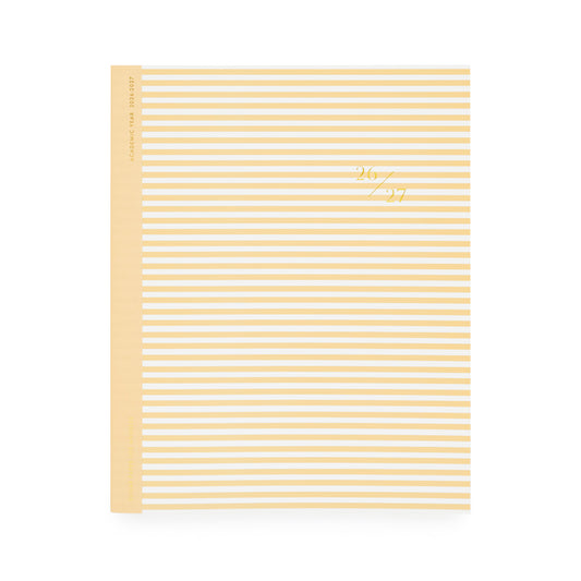 Yellow and white striped planner with '26 27' in gold foil on cover with yellow tape binding