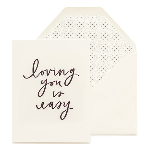 cream card with black text, cream envelope with black pindot liner