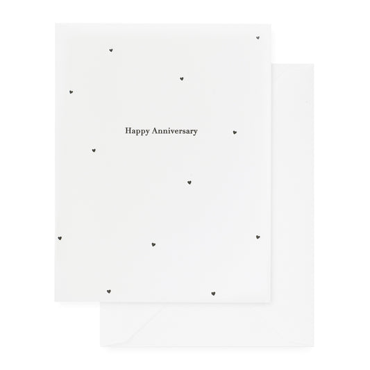 white anniversary card with black text and hearts, white envelope
