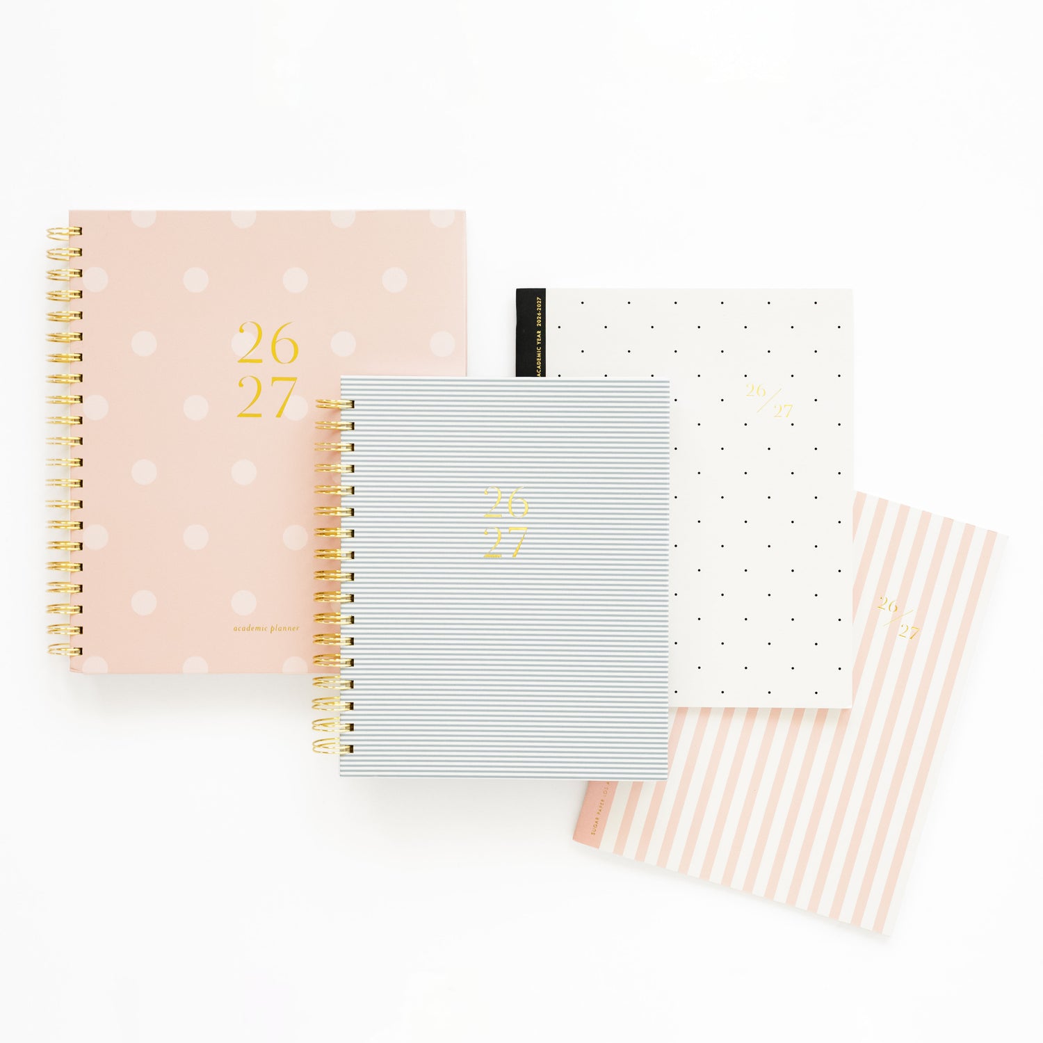 Four planners with different designs on a white background
