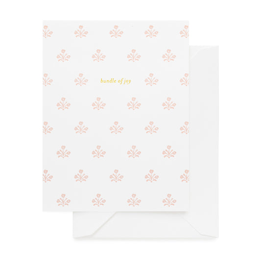 white card with pink floral pattern and gold bundle of joy text