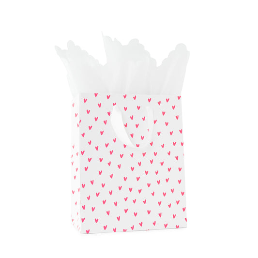 Pink neon heart gift bag with white handles with white scallop tissue paper