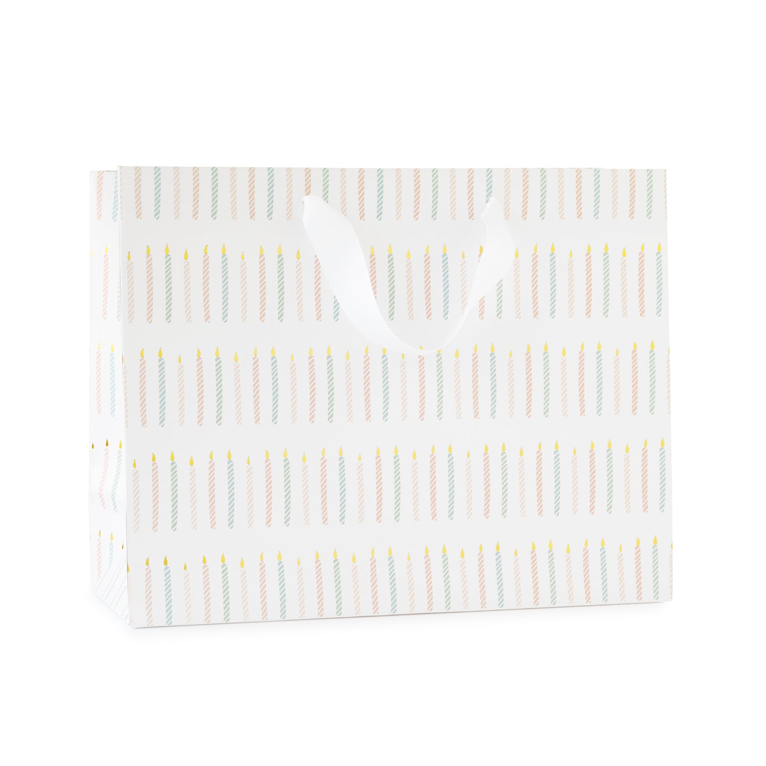 large gift bag with white ribbon handles printed with a colorful candle pattern in pink and blue with gold foil}