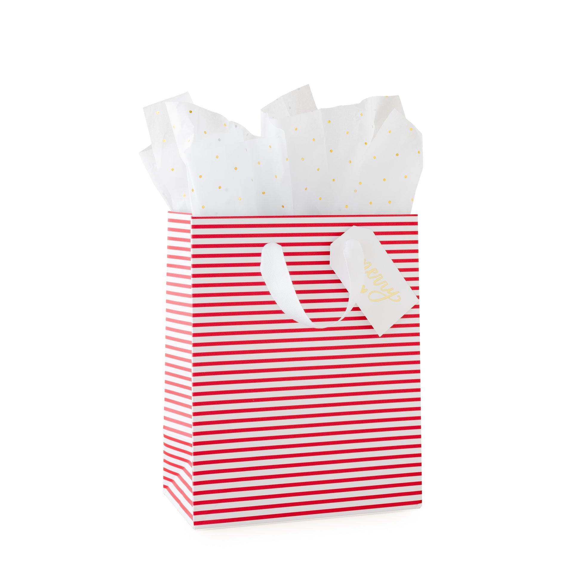Red and white striped gift bag with a white gift tag with 'merry' and a heart printed in gold foil with gold dot tissue paper