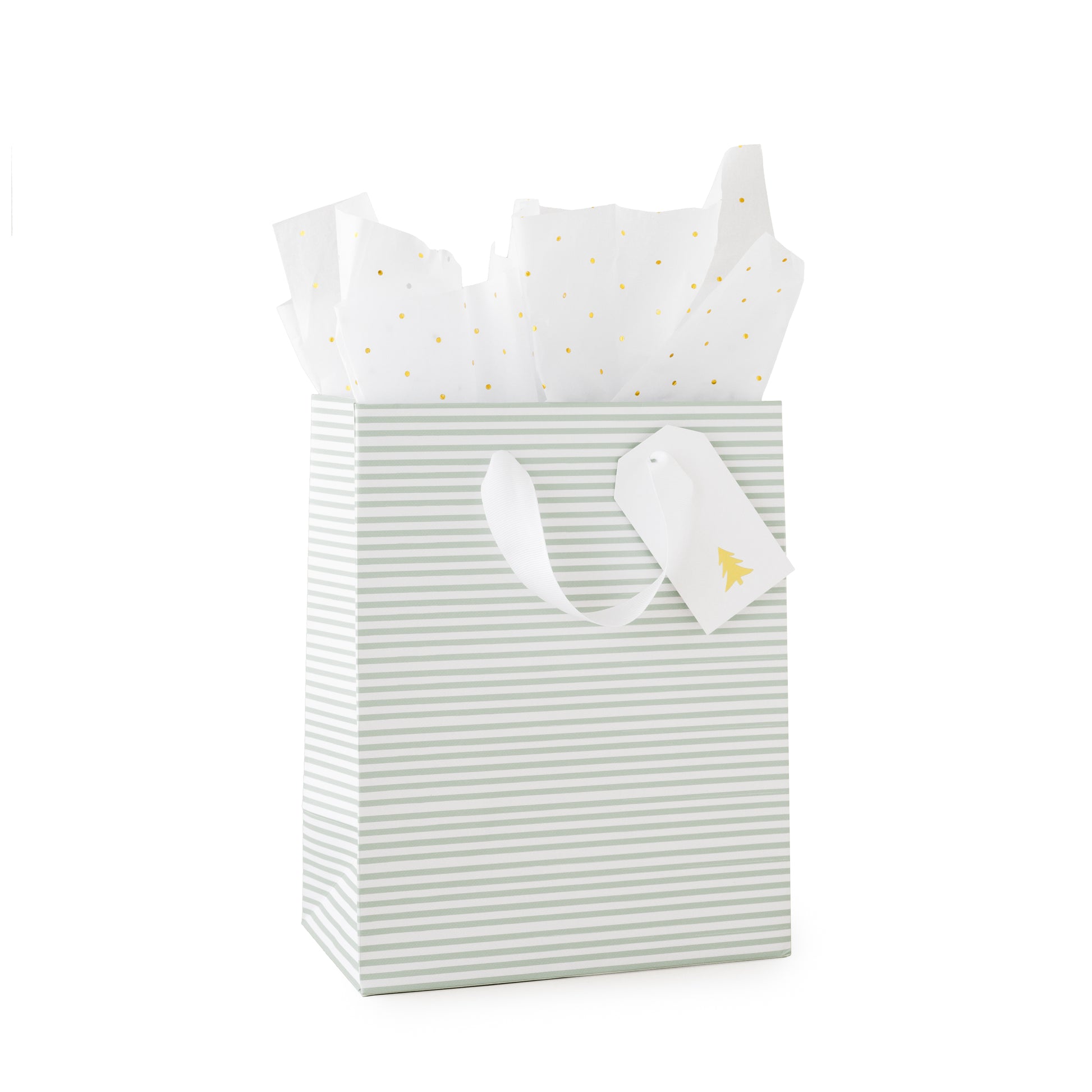 Green stripe gift bag filled with gold foil dot tissue paper with white ribbon handles, white gift tag with gold christmas tree
