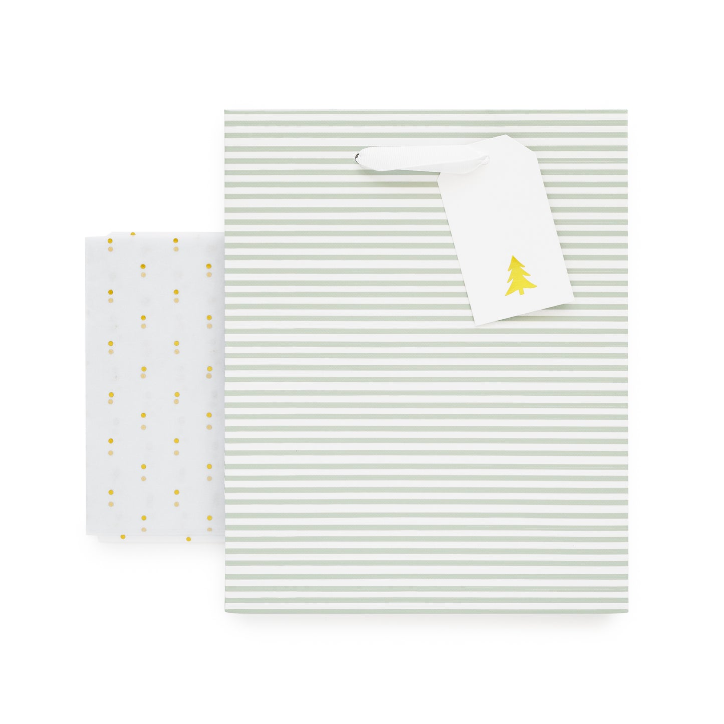Green stripe gift bag with white ribbon handles, white gift tag with gold christmas tree, and gold foil dot tissue paper
