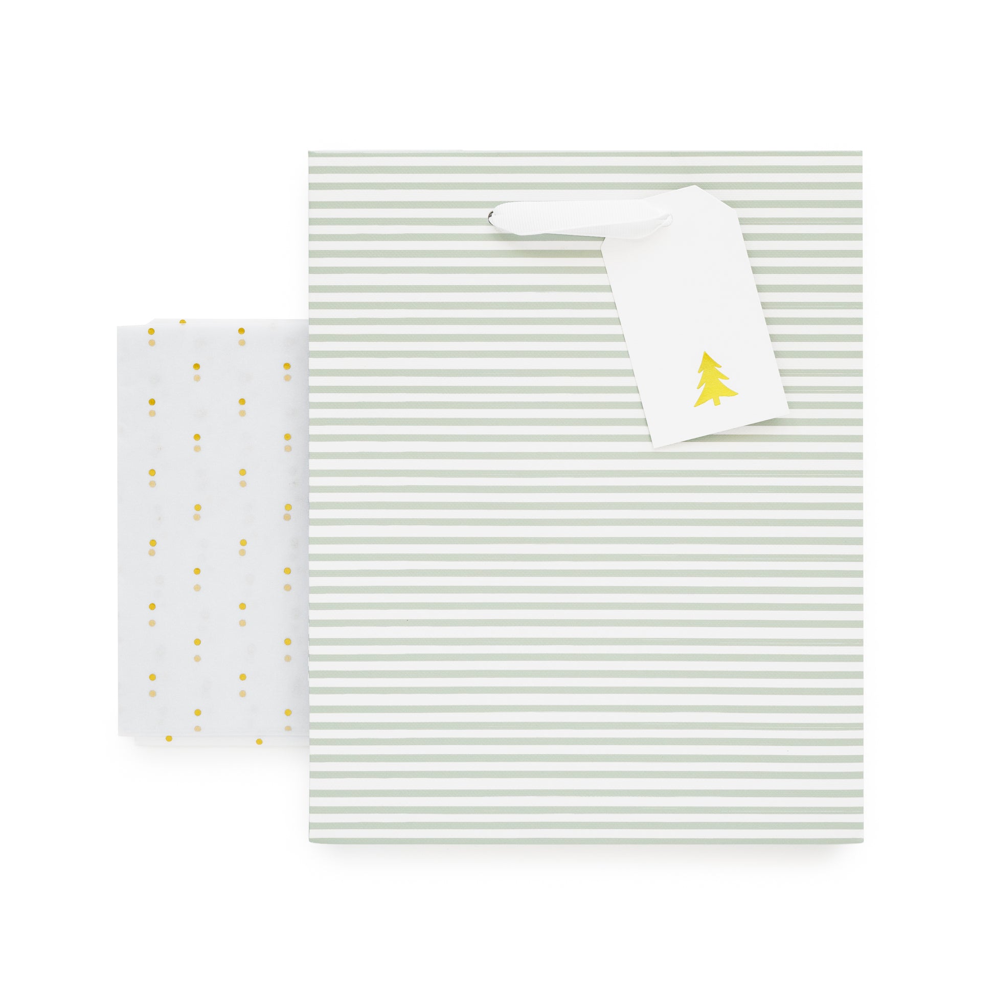 Green stripe gift bag with white ribbon handles, white gift tag with gold christmas tree, and gold foil dot tissue paper
