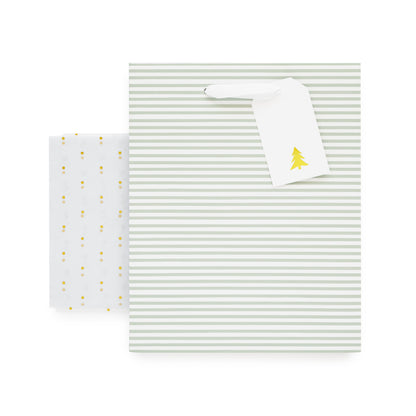 Green stripe gift bag with white ribbon handles, white gift tag with gold christmas tree, and gold foil dot tissue paper