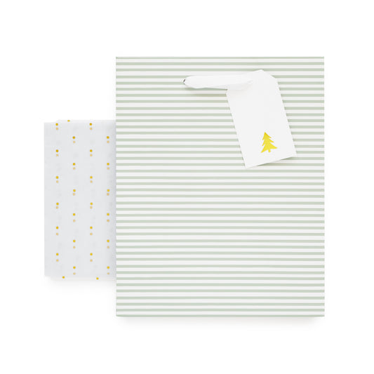 Green stripe gift bag with white ribbon handles, white gift tag with gold christmas tree, and gold foil dot tissue paper