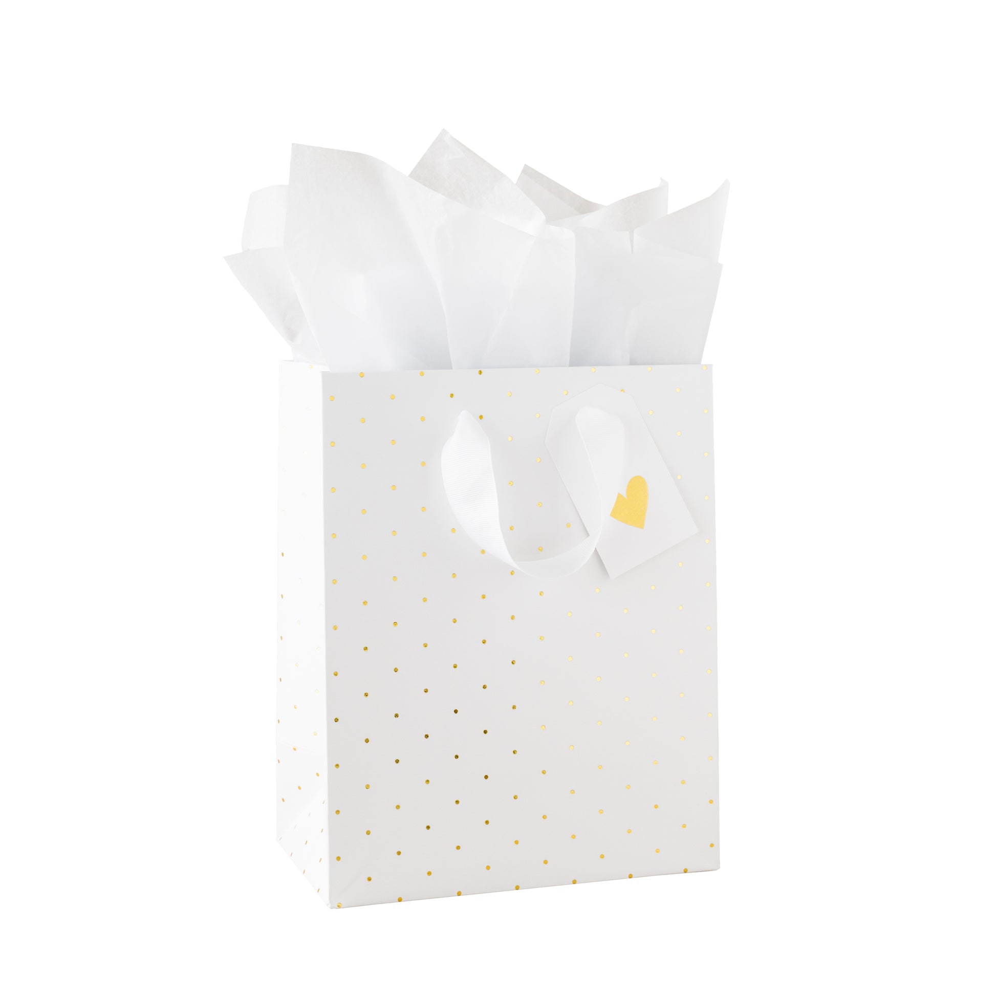 White gift bag with gold polka dots, white tissue paper, and a gold heart tag