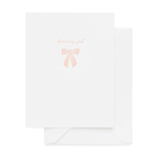 Pale pink printed birthday girl with a pink bow on white card