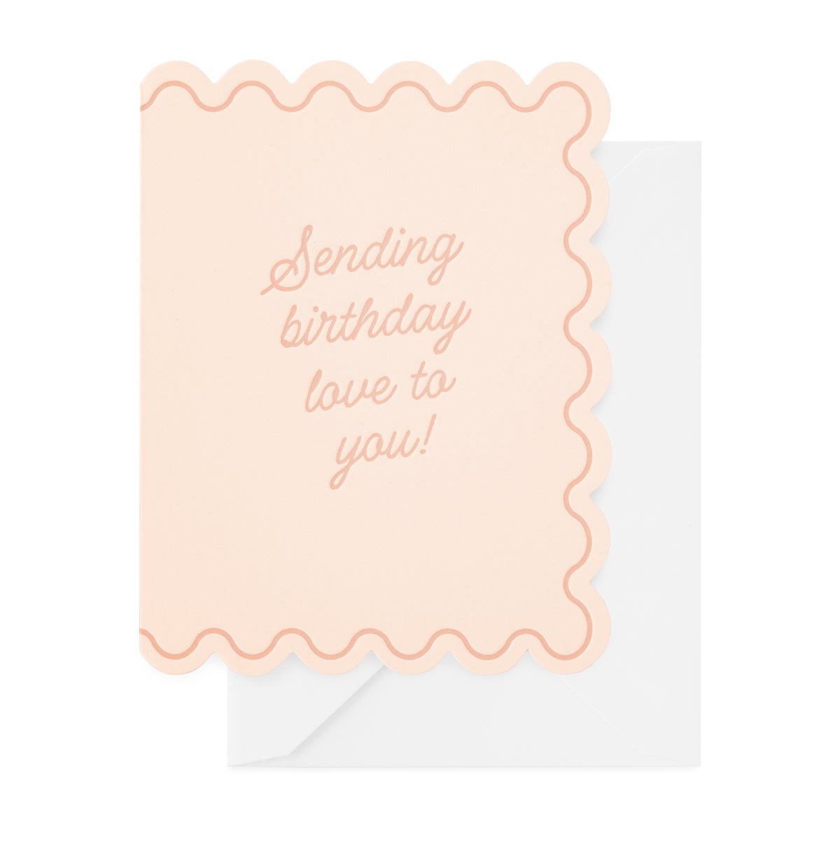 A pale pink birthday card with scallop edges printed in rose ink with 'sending birthday love to you' paired with a white envelope