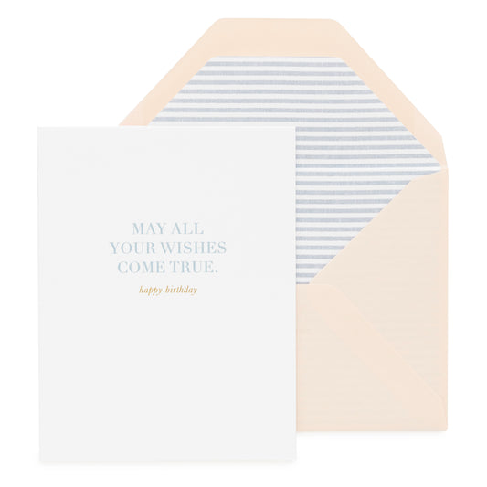 White card with blue text 'may all your wishes come true' and gold foil 'happy birthday' paired with a pink envelope with blue striped liner