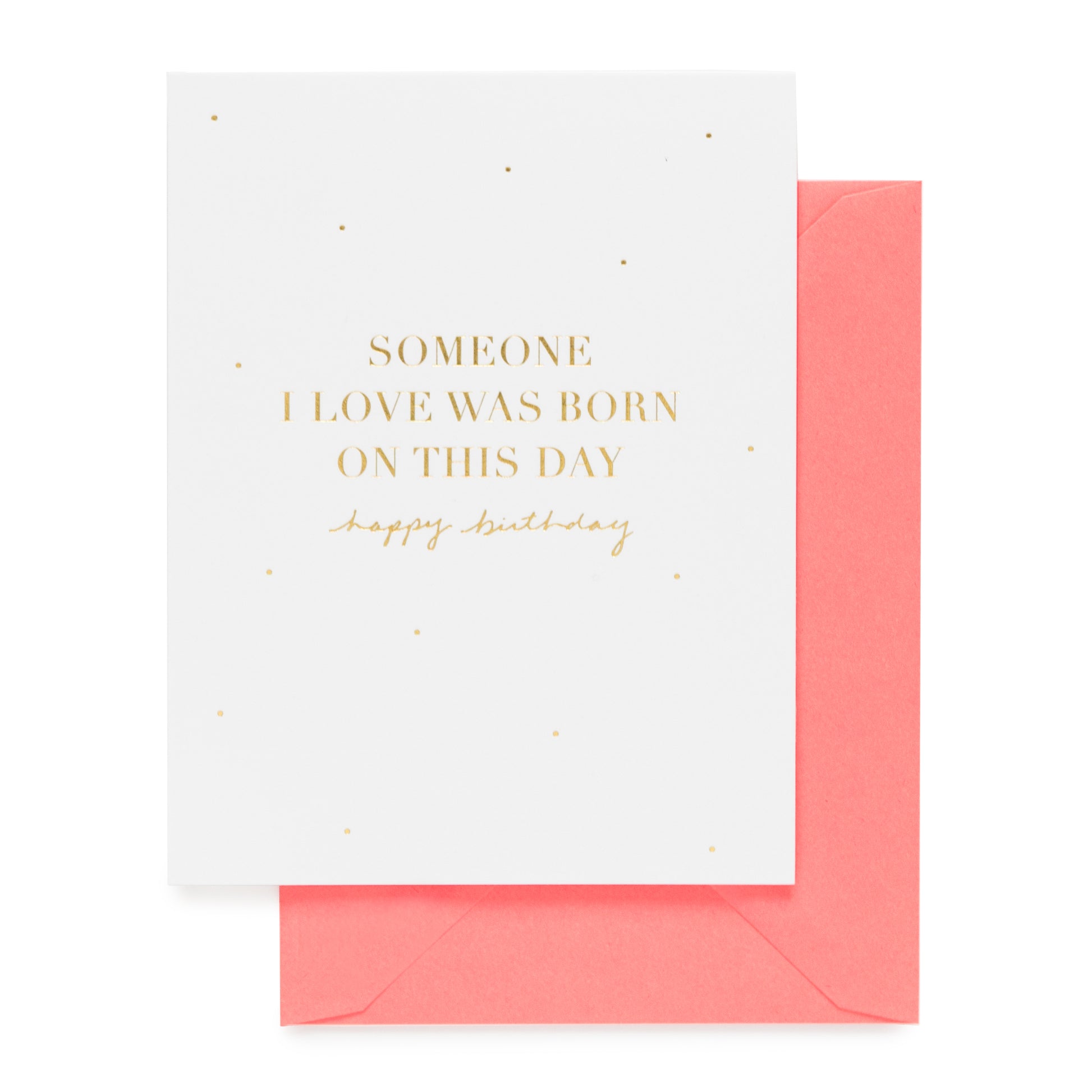 Greeting card with gold foil 'someone i love was born on this day happy birthday' on a white background with a neon coral envelope.