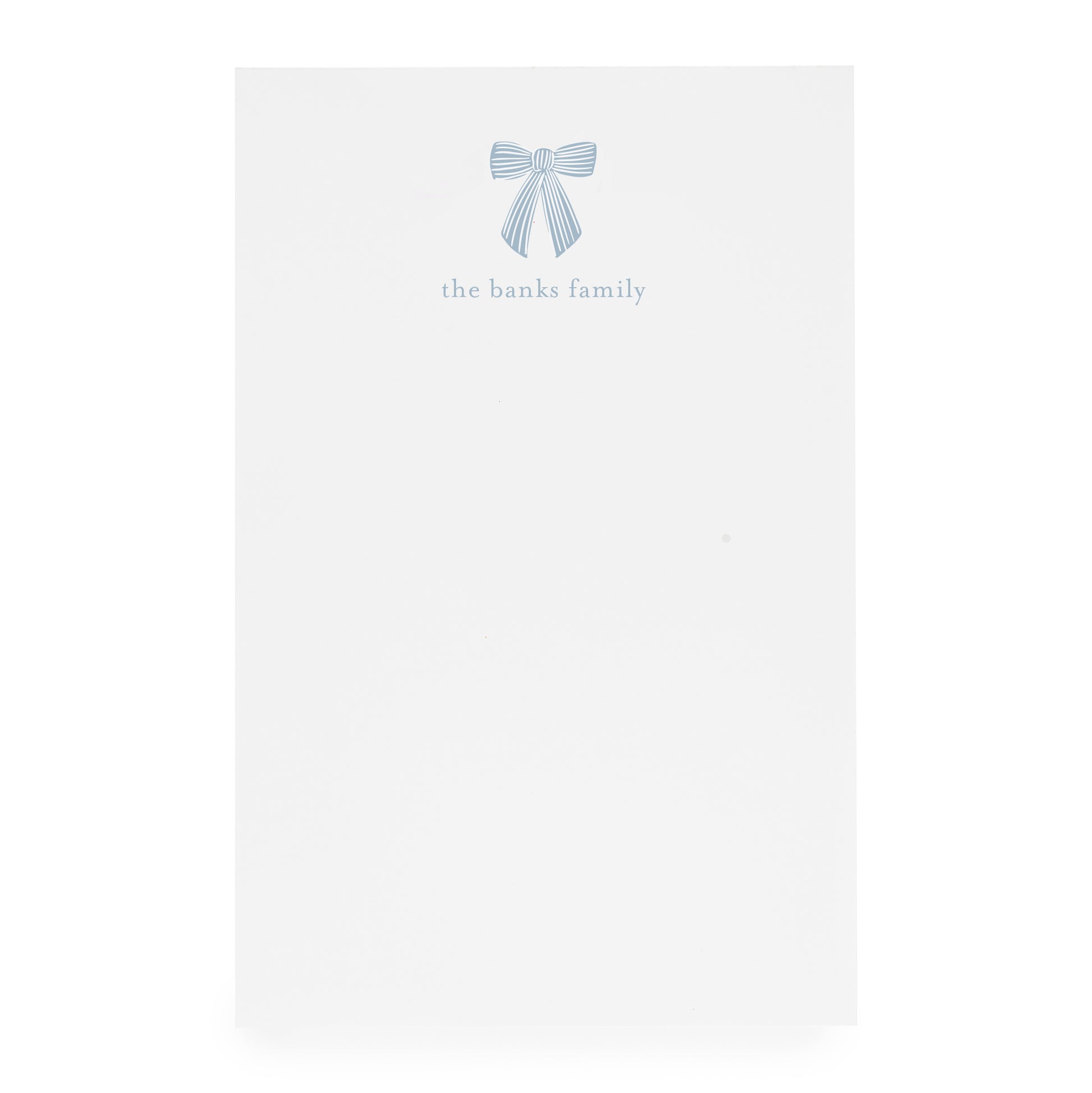 White paper with a blue bow design and 'the banks family' text on white paper
