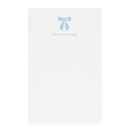 White paper with a blue bow design and 'the banks family' text on white paper