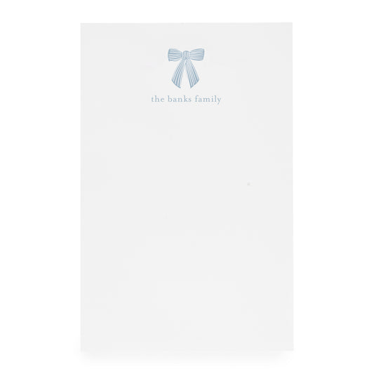 White paper with a blue bow design and 'the banks family' text on white paper
