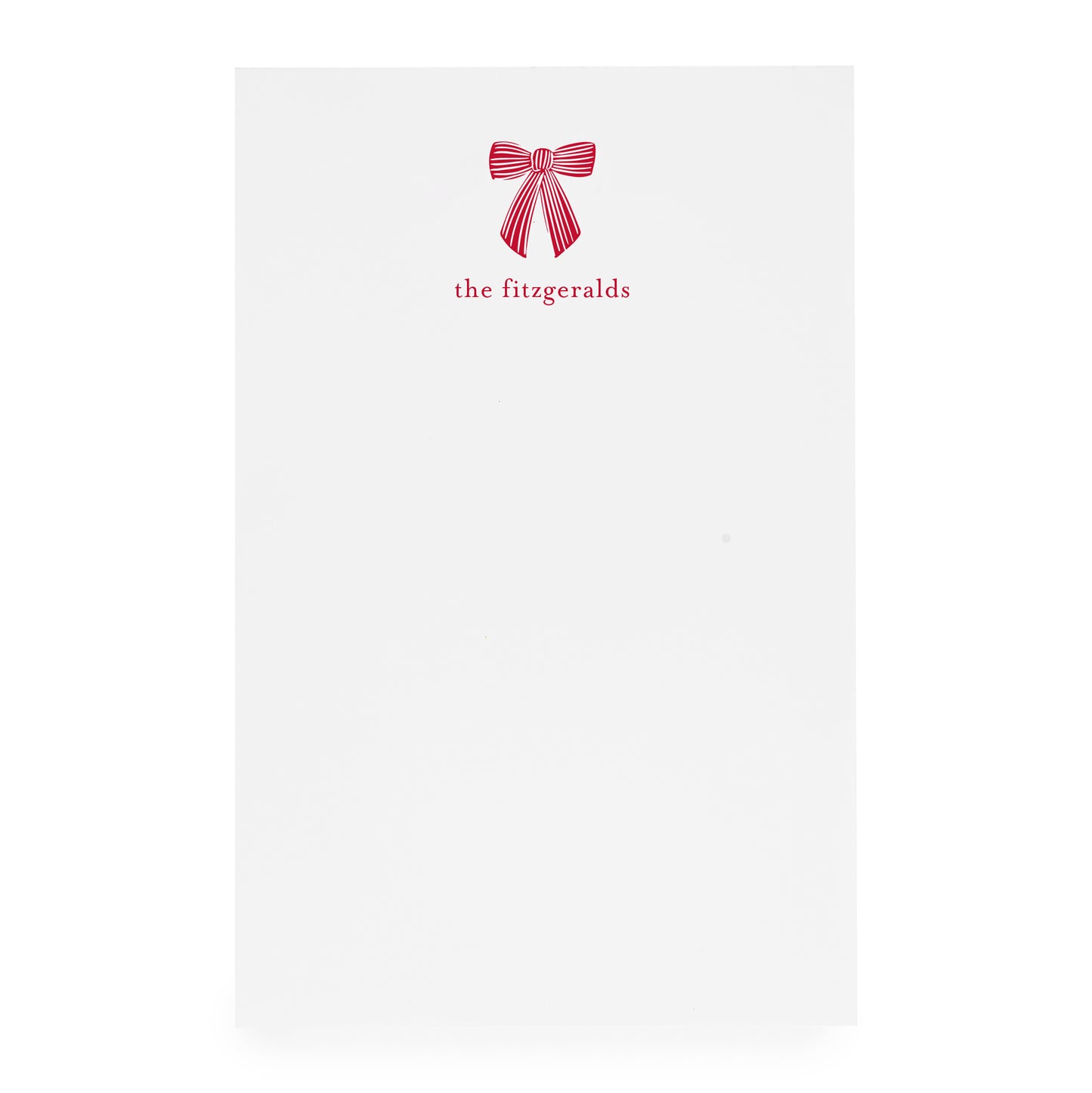 White paper with a red bow design and 'the fitzgeralds' text on white paper