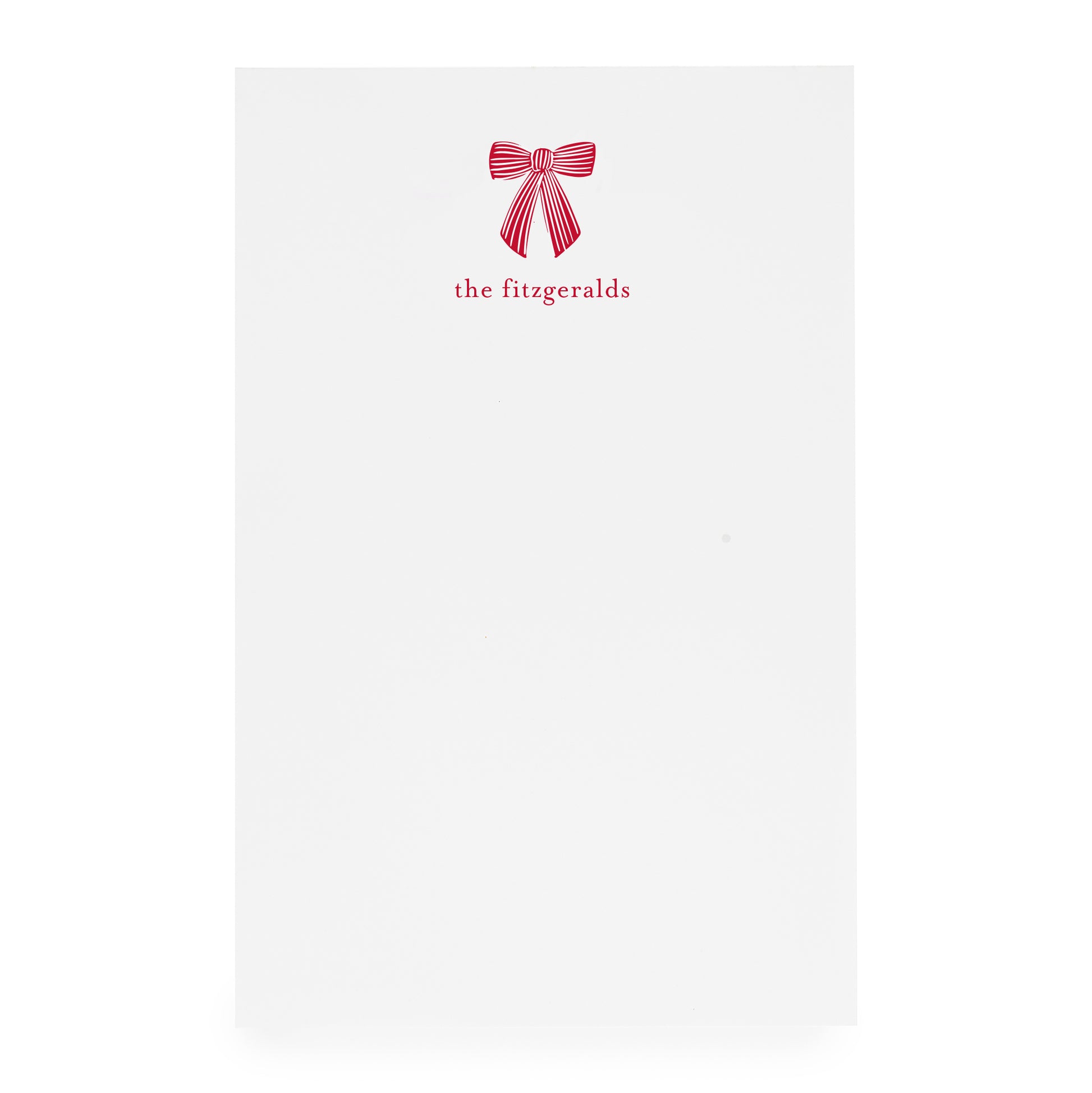 White paper with a red bow design and 'the fitzgeralds' text on white paper