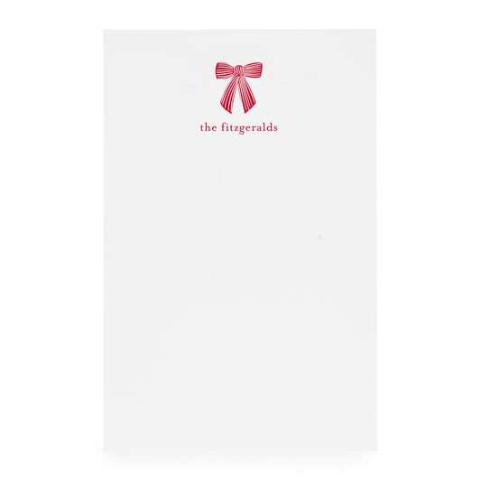 White paper with a red bow design and 'the fitzgeralds' text on white paper