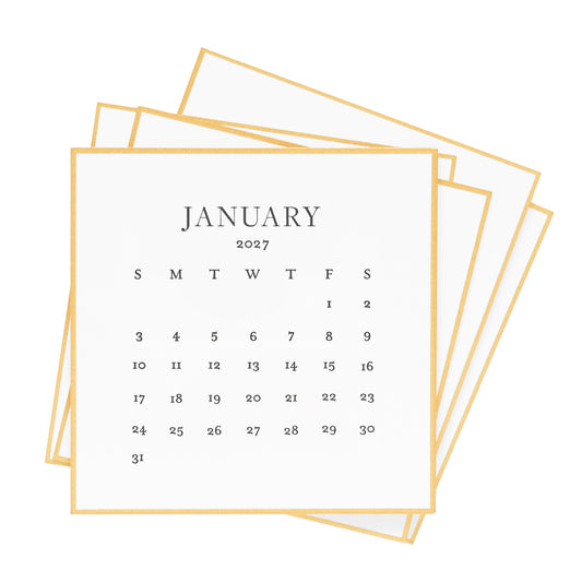 A stack of 2027 calendar sheets with a gold hand painted border, and black letterpress ink printed with 'january 2027' and dates of the month