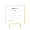 Gold bordered 2024 calendar card printed in black ink on brass stand